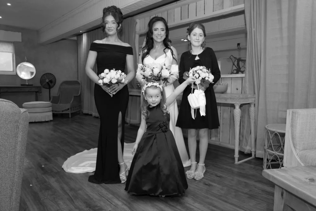 The bride with her bridesmaids and a flower girl, in black and white