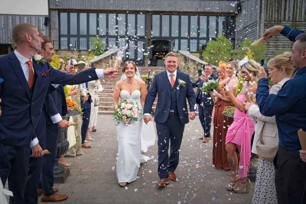Guests shower the bride and groom with confetti at South Causey Inn