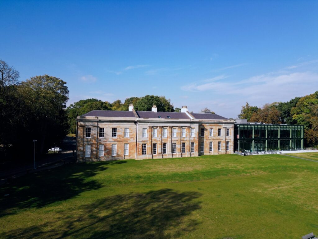 A Georgian country house in its parkland, seen from the air