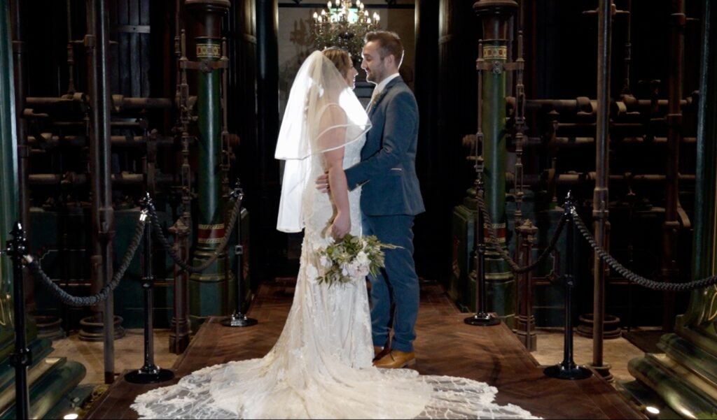 Bride and groom among green Victorian pumping engines